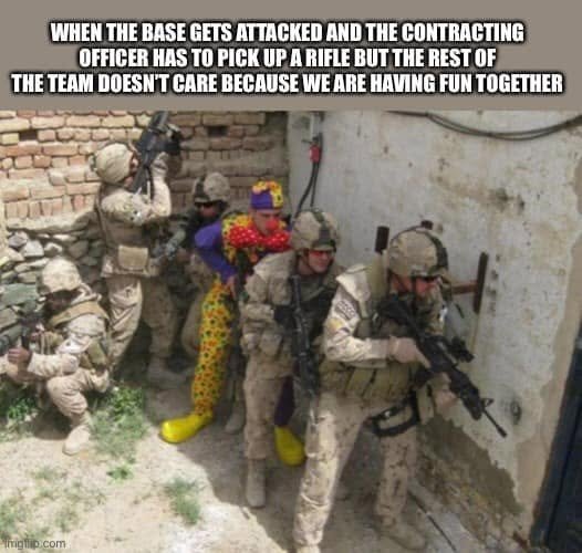 An armed team includes a person dressed as a clown; caption describes the contracting officer picking up a rifle during a base attack while the team enjoys being together.