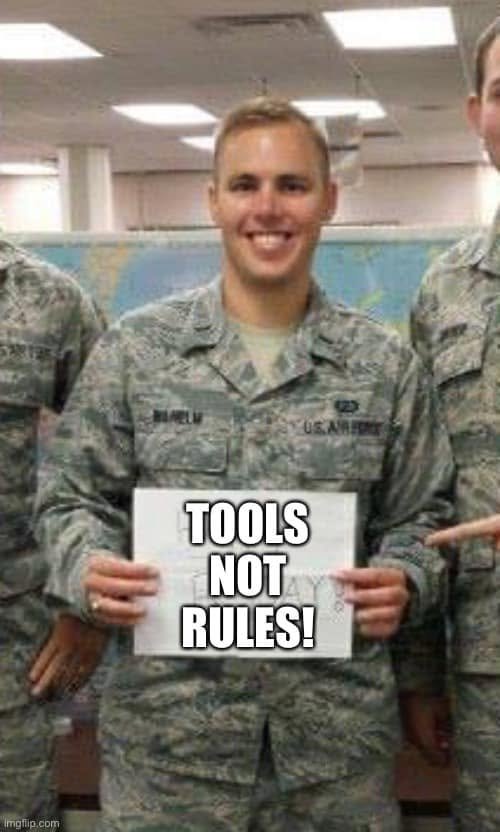 Source photograph of an Air Force member holding a certificate overlaid TOOLS NOT RULES; the post caption identifies Timothy Wilhelm.